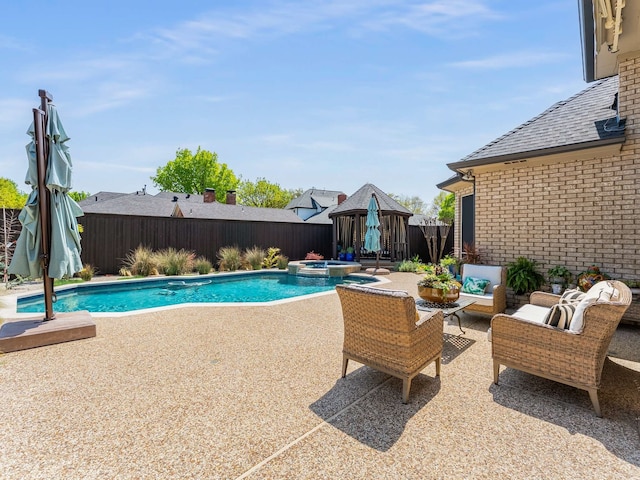 view of pool featuring a gazebo, a pool with connected hot tub, an outdoor hangout area, a fenced backyard, and a patio