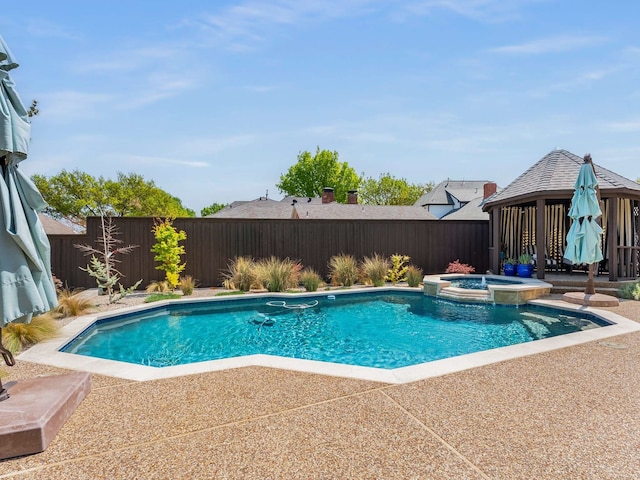 view of pool with a gazebo, a fenced backyard, a pool with connected hot tub, and a patio