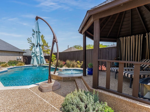 view of swimming pool featuring a gazebo, a fenced backyard, and a pool with connected hot tub