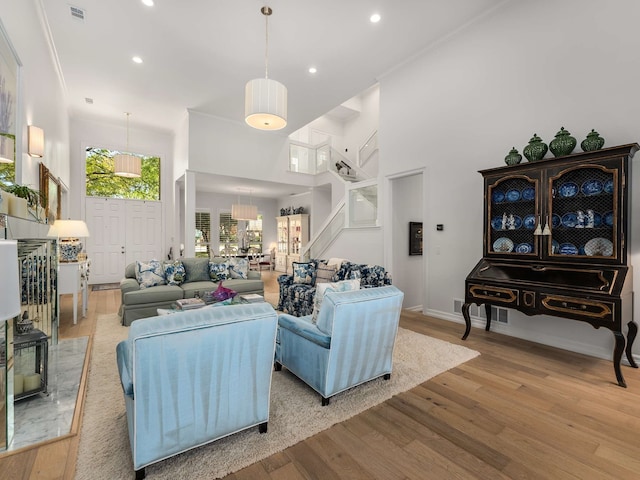 living area with recessed lighting, light wood-style flooring, and visible vents