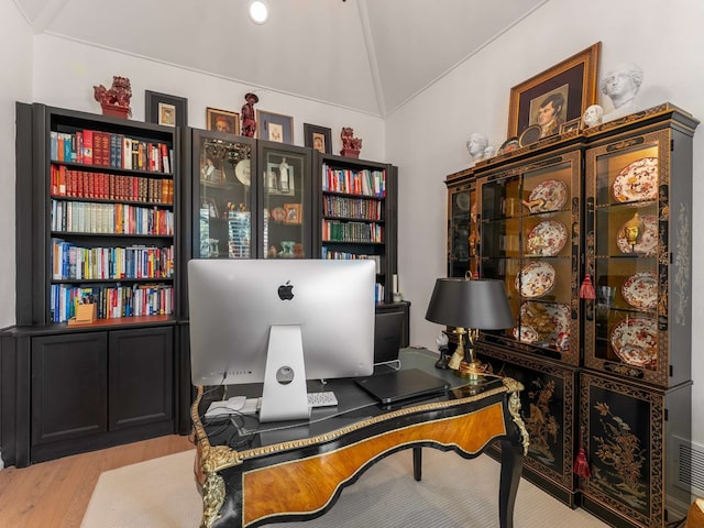 office area with lofted ceiling and wood finished floors
