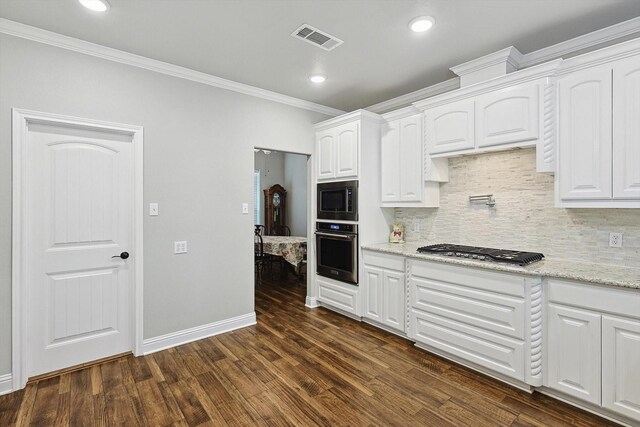kitchen with crown molding, appliances with stainless steel finishes, dark wood finished floors, visible vents, and white cabinets