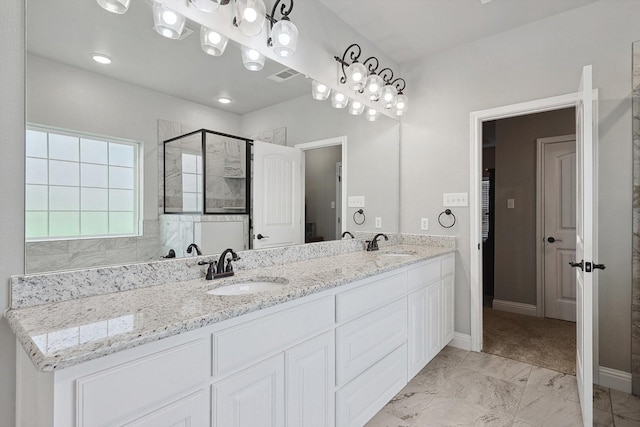bathroom with marble finish floor, a sink, a tile shower, and visible vents