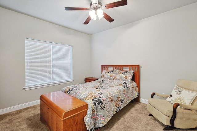 carpeted bedroom featuring baseboards and ceiling fan