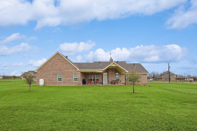 view of front of property with a front lawn, a shingled roof, and brick siding