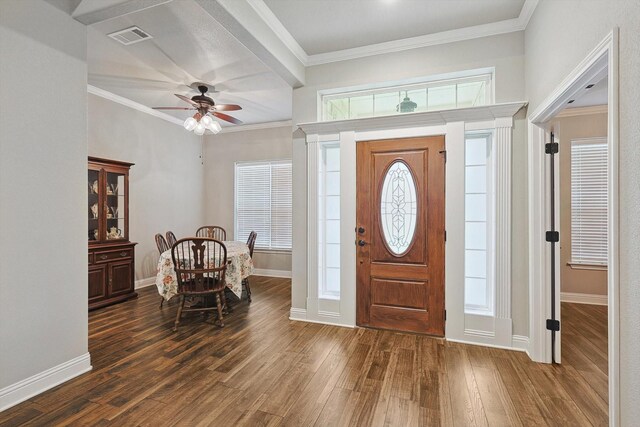entryway with visible vents, crown molding, baseboards, ceiling fan, and wood finished floors