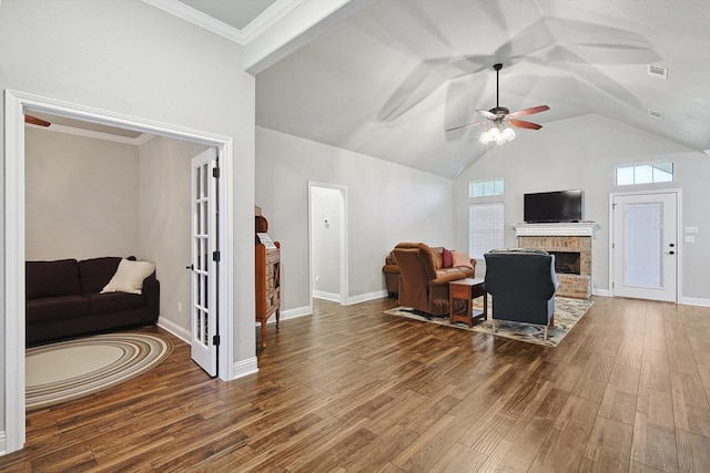 living room with visible vents, a brick fireplace, ceiling fan, wood finished floors, and french doors