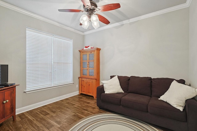 living room featuring baseboards, ornamental molding, wood finished floors, and a ceiling fan