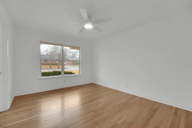 unfurnished room featuring ceiling fan, baseboards, and light wood-style floors