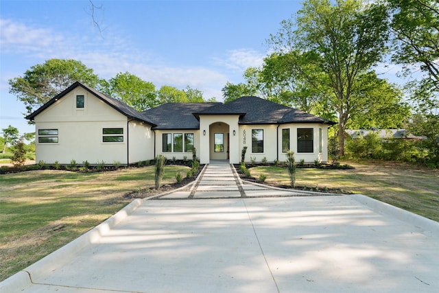 6048 Vz County Rd Unit 2120, Wills Point, TX 75169 - view of front of house featuring a shingled roof, a front yard, and stucco siding