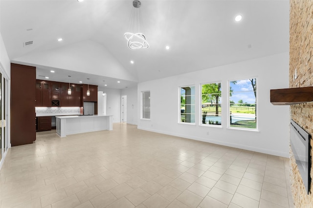 6048 Vz County Rd Unit 2120, Wills Point, TX 75169 - unfurnished living room with high vaulted ceiling, a fireplace, visible vents, and recessed lighting