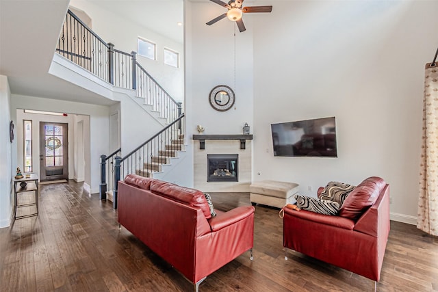 living area featuring a ceiling fan, stairway, and hardwood / wood-style floors