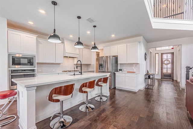 kitchen featuring light countertops, white cabinets, and stainless steel appliances