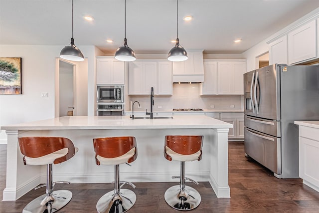 kitchen featuring backsplash, light countertops, stainless steel appliances, and white cabinetry