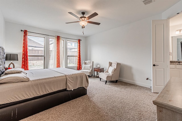 carpeted bedroom featuring baseboards, ceiling fan, and visible vents