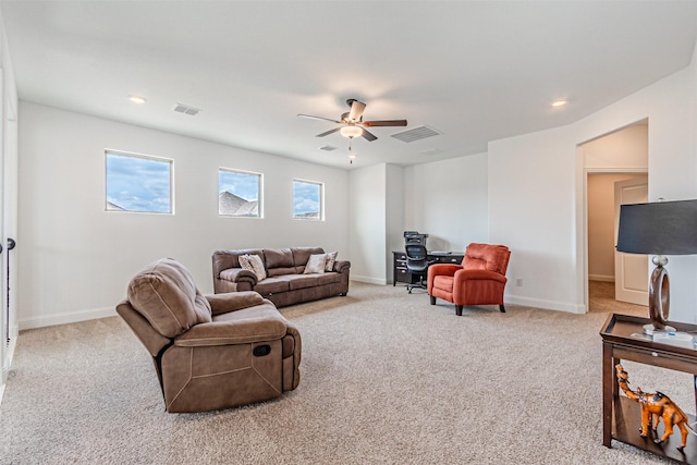carpeted living room with baseboards, visible vents, and ceiling fan