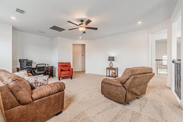 living room with carpet flooring, baseboards, ceiling fan, and visible vents