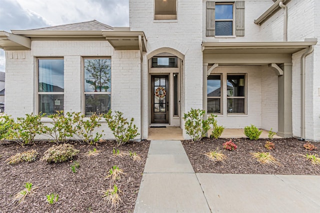 property entrance featuring brick siding