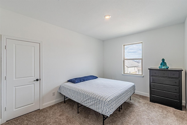 bedroom with baseboards and carpet floors