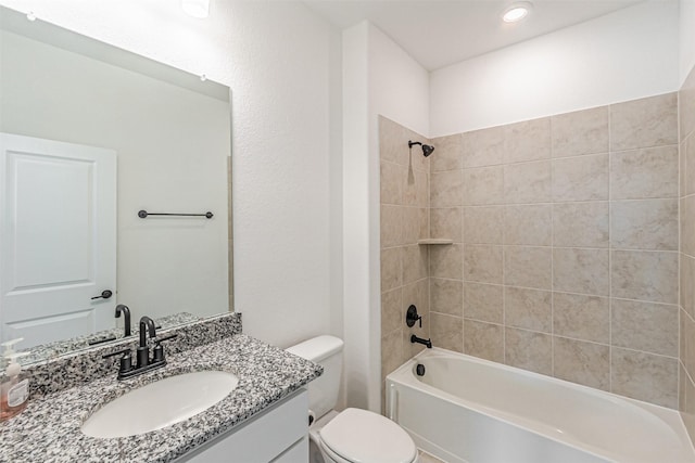 bathroom featuring toilet, vanity, and shower / bathtub combination