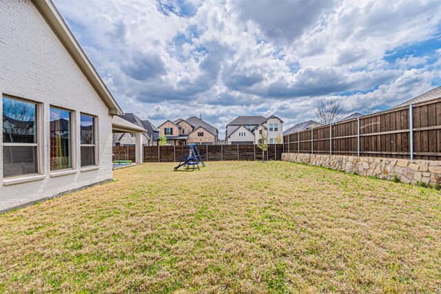 view of yard with a fenced backyard and a residential view