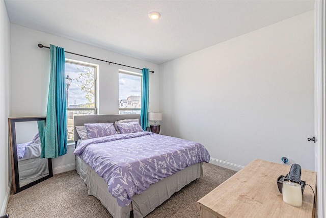 carpeted bedroom with baseboards