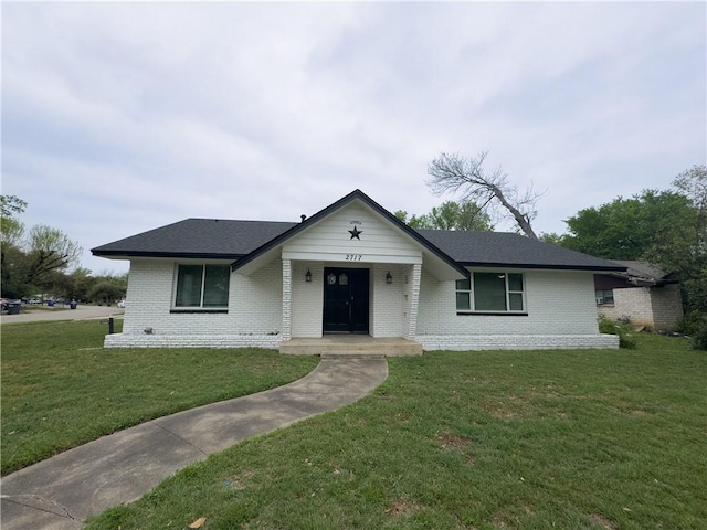 2717 Old Robinson Rd, Waco, TX 76706 - view of front facade with brick siding, a front lawn, and a shingled roof