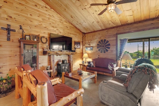 living area featuring wooden walls, wood ceiling, and a wood stove