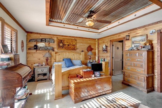 bedroom featuring wood walls, light carpet, and a raised ceiling