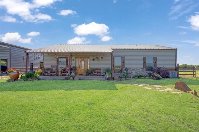rear view of property featuring a yard, central AC, fence, and a porch