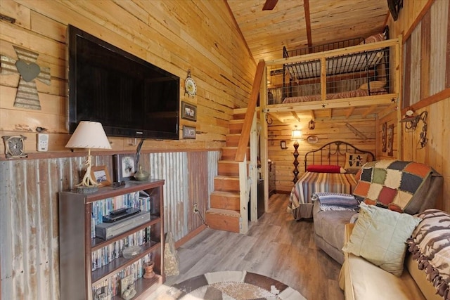living room featuring wooden ceiling, vaulted ceiling, wood walls, and wood finished floors
