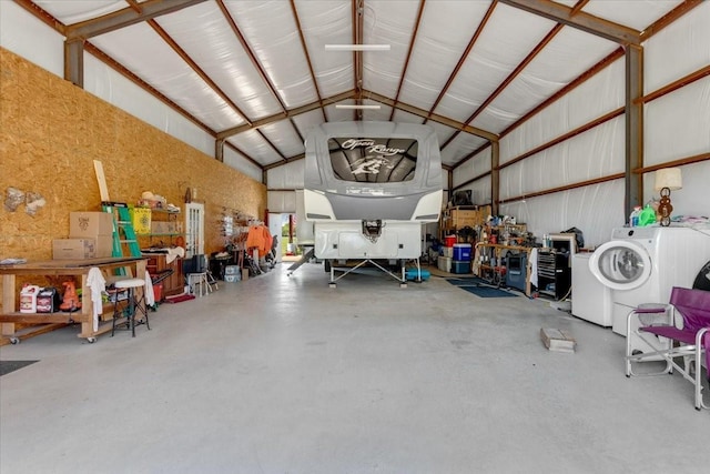 garage featuring washer / clothes dryer and a workshop area