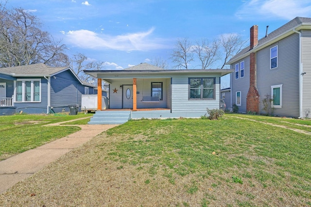 bungalow-style house with a porch and a front lawn