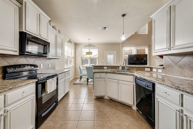 kitchen featuring a sink, a peninsula, light tile patterned floors, visible vents, and black appliances