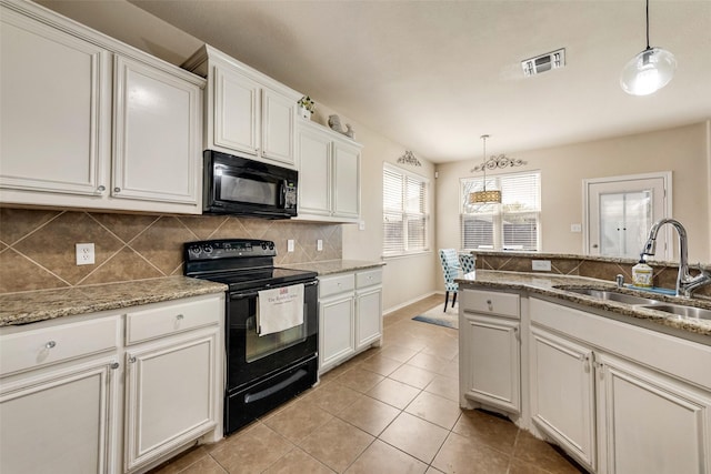 kitchen featuring a sink, pendant lighting, light tile patterned floors, black appliances, and decorative backsplash