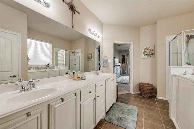 full bathroom featuring tile patterned floors, a sink, a stall shower, and double vanity