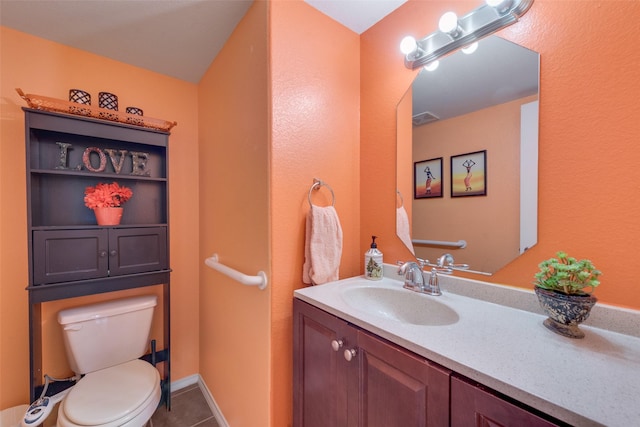bathroom featuring visible vents, toilet, tile patterned flooring, and vanity