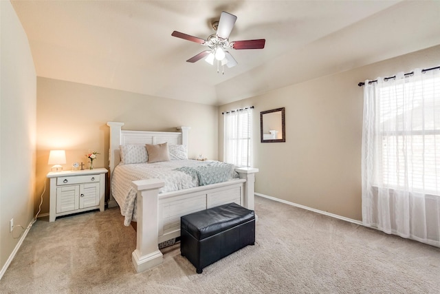 bedroom featuring a ceiling fan, light carpet, and baseboards
