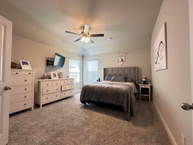 carpeted bedroom with a ceiling fan, baseboards, and visible vents