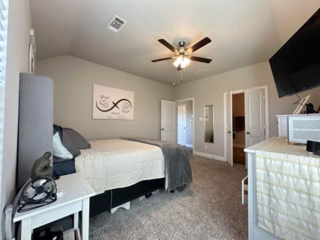 bedroom featuring lofted ceiling, baseboards, carpet floors, visible vents, and a ceiling fan