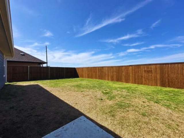 view of yard with a fenced backyard