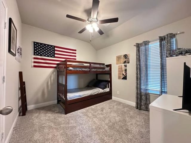 bedroom with carpet floors, a ceiling fan, multiple windows, lofted ceiling, and baseboards