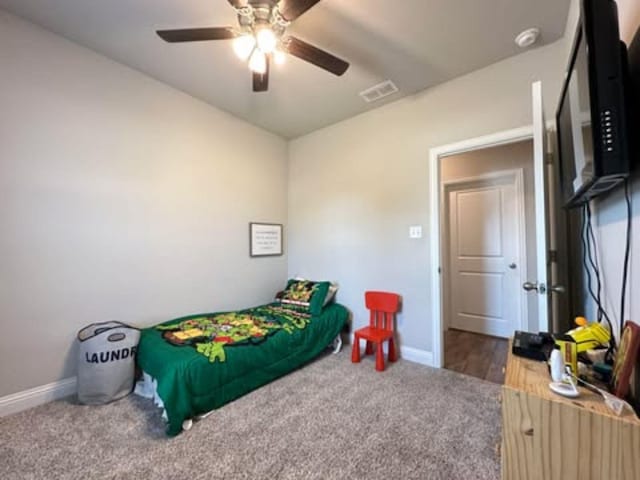 bedroom featuring baseboards, visible vents, ceiling fan, and carpet flooring