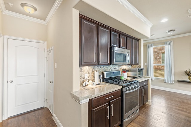 kitchen featuring ornamental molding, dark brown cabinetry, and appliances with stainless steel finishes