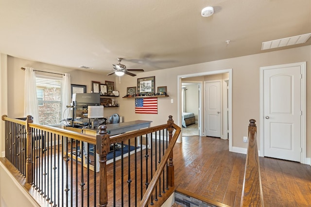 interior space featuring ceiling fan, visible vents, and wood finished floors