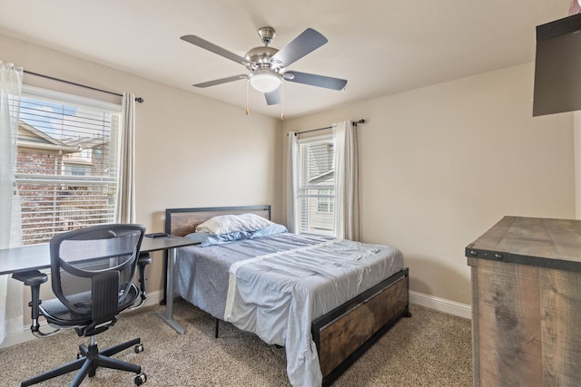 bedroom with multiple windows, carpet floors, baseboards, and a ceiling fan