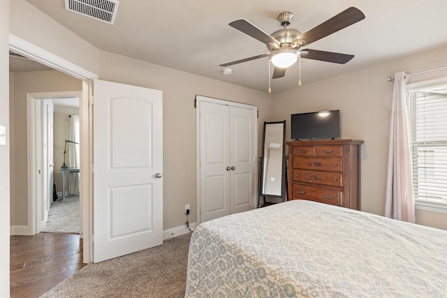 bedroom with a ceiling fan, baseboards, a closet, and visible vents
