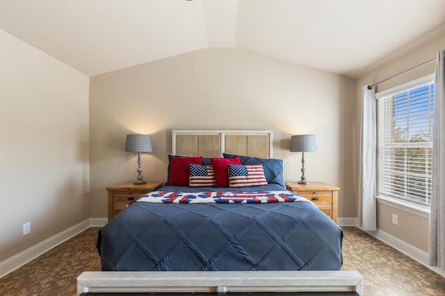 bedroom with baseboards and vaulted ceiling