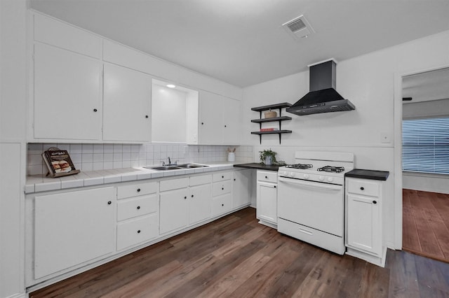 1326 W Shepherd St, Denison, TX 75020 - kitchen featuring white gas stove, wall chimney range hood, a sink, open shelves, and white cabinets