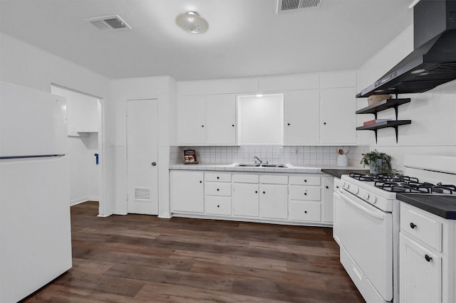 1326 W Shepherd St, Denison, TX 75020 - kitchen featuring white appliances, wall chimney range hood, open shelves, a sink, and white cabinets